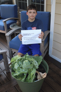 Cabbage Program participant with sign